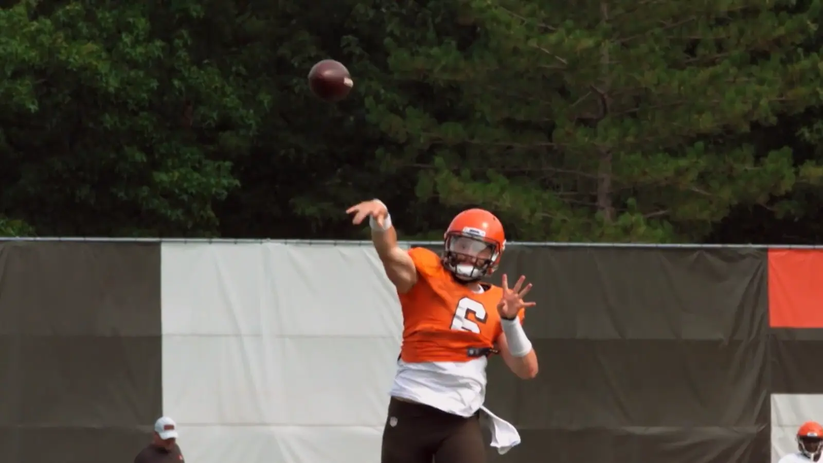 A quarterback releasing a football
